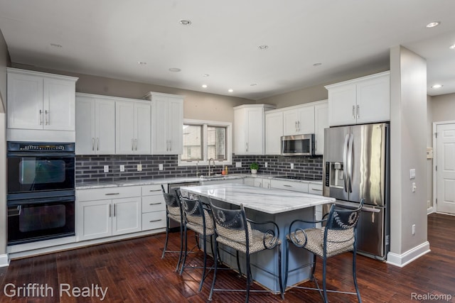 1804 Morgan Lake Ct, Brighton, MI 48114 - kitchen with black appliances, dark wood-type flooring, white cabinetry, and recessed lighting