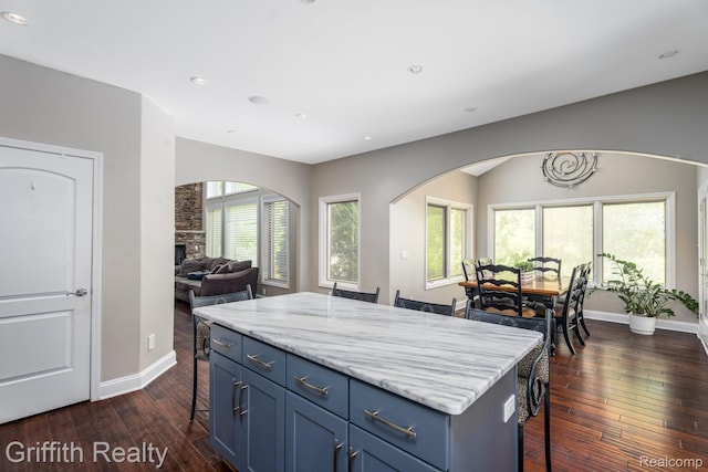 1804 Morgan Lake Ct, Brighton, MI 48114 - kitchen with blue cabinetry, open floor plan, dark wood-type flooring, a breakfast bar, and recessed lighting