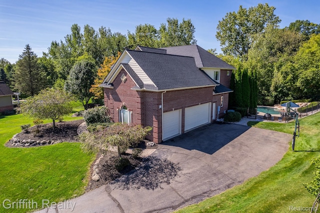 1804 Morgan Lake Ct, Brighton, MI 48114 - view of property exterior with brick siding, driveway, a yard, and a garage