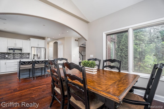 1804 Morgan Lake Ct, Brighton, MI 48114 - dining area with arched walkways, dark wood-style floors, and lofted ceiling