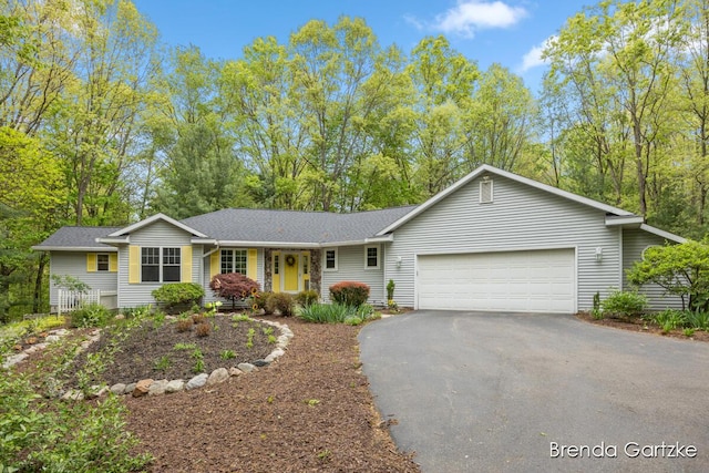 5291 Bonasa Dr NE, Rockford, MI 49341 - ranch-style home with a garage, asphalt driveway, and roof with shingles