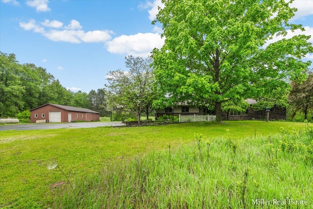 4700 M-79, Nashville, MI 49073 - view of grassy yard featuring a detached garage, an outdoor structure, and driveway