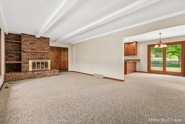 4700 M-79, Nashville, MI 49073 - unfurnished living room with baseboards, beamed ceiling, light colored carpet, a brick fireplace, and a chandelier