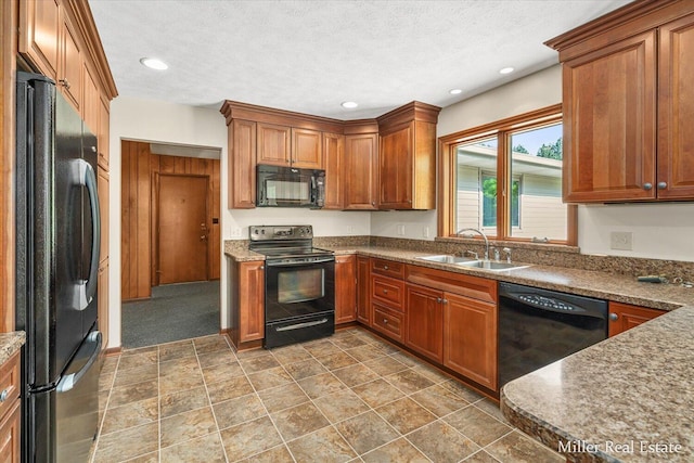 4700 M-79, Nashville, MI 49073 - kitchen with black appliances, a sink, brown cabinetry, recessed lighting, and dark stone finish flooring