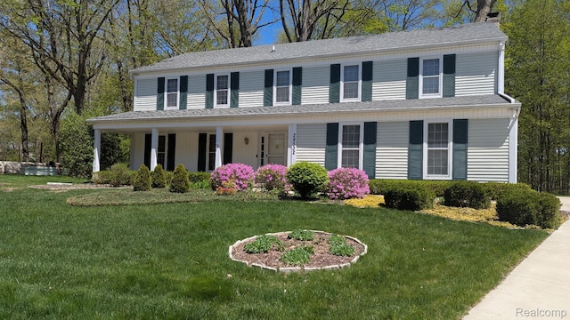 28532 Perryville Way, Farmington Hills, MI 48331 - colonial-style house featuring covered porch, a front lawn, and a shingled roof