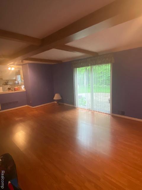 28532 Perryville Way, Farmington Hills, MI 48331 - unfurnished living room with wood finished floors and beam ceiling