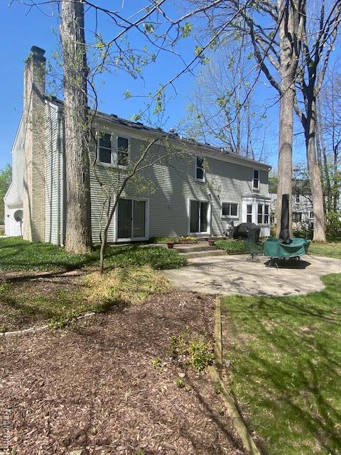 28532 Perryville Way, Farmington Hills, MI 48331 - rear view of property with a chimney and a patio