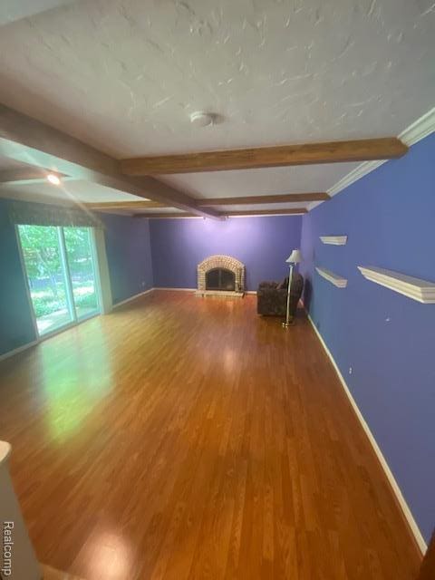 28532 Perryville Way, Farmington Hills, MI 48331 - unfurnished living room featuring a brick fireplace, beam ceiling, and wood finished floors