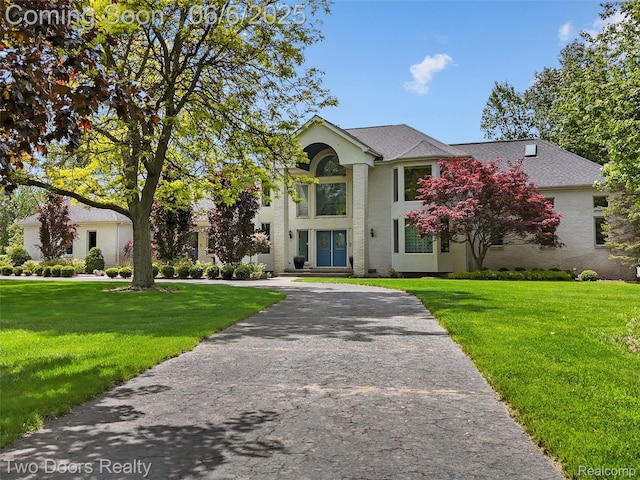 532 Shrewsbury Dr, Clarkston, MI 48348 - greek revival inspired property with a front yard, driveway, and roof with shingles