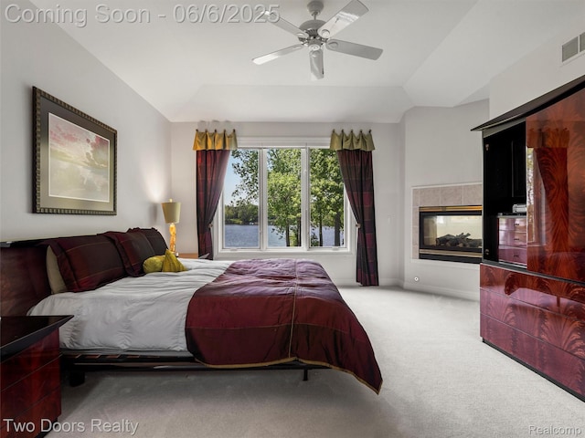 532 Shrewsbury Dr, Clarkston, MI 48348 - carpeted bedroom featuring a tile fireplace, vaulted ceiling, and a ceiling fan