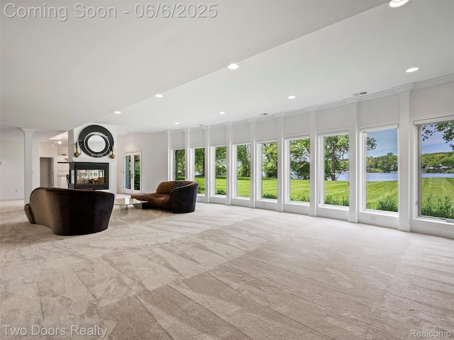 532 Shrewsbury Dr, Clarkston, MI 48348 - living room with carpet floors, a water view, a multi sided fireplace, recessed lighting, and decorative columns