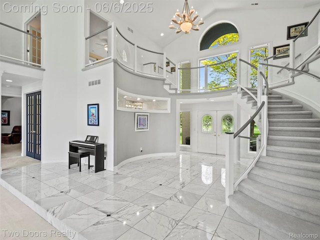532 Shrewsbury Dr, Clarkston, MI 48348 - entryway with french doors, marble tiled flooring, a towering ceiling, stairs, and a chandelier