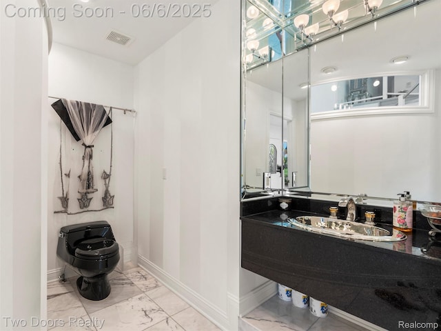 532 Shrewsbury Dr, Clarkston, MI 48348 - bathroom featuring toilet, a sink, marble look tile flooring, and baseboards