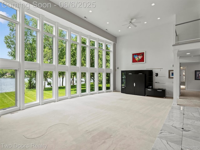 532 Shrewsbury Dr, Clarkston, MI 48348 - living room with a towering ceiling, ceiling fan, recessed lighting, marble look tiles, and a water view