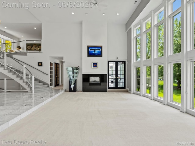 532 Shrewsbury Dr, Clarkston, MI 48348 - unfurnished living room featuring a towering ceiling, recessed lighting, french doors, and stairway