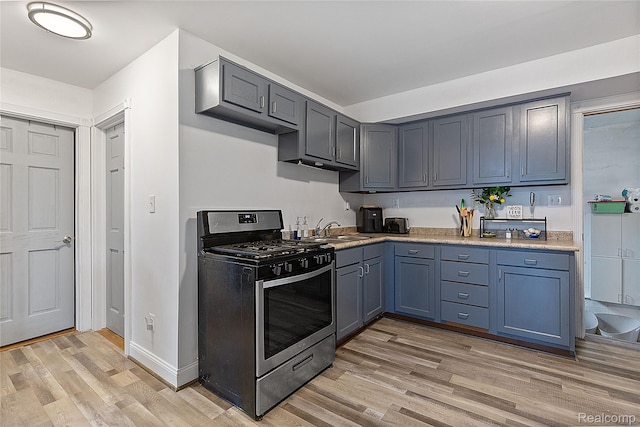 13902 Toepfer Rd, Warren, MI 48089 - kitchen with stainless steel gas range oven, light wood-style flooring, a sink, and light countertops