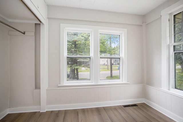 40 Eldredge St, Battle Creek, MI 49037 - empty room featuring wood finished floors, plenty of natural light, and baseboards