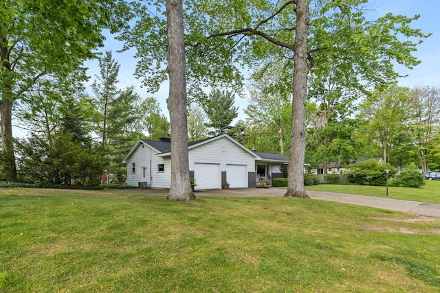 2294 Pinewood St, Jenison, MI 49428 - view of side of property with a garage, a lawn, driveway, and a chimney