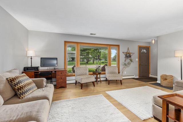 2294 Pinewood St, Jenison, MI 49428 - living area featuring a baseboard heating unit, wood finished floors, and baseboard heating