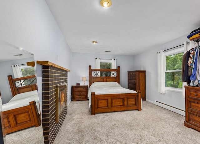 2294 Pinewood St, Jenison, MI 49428 - bedroom featuring baseboard heating, a brick fireplace, carpet floors, and multiple windows