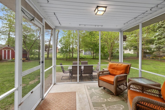 2294 Pinewood St, Jenison, MI 49428 - sunroom / solarium featuring rail lighting, healthy amount of natural light, and outdoor dining space
