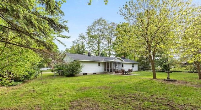 2294 Pinewood St, Jenison, MI 49428 - back of property with a lawn and a patio area