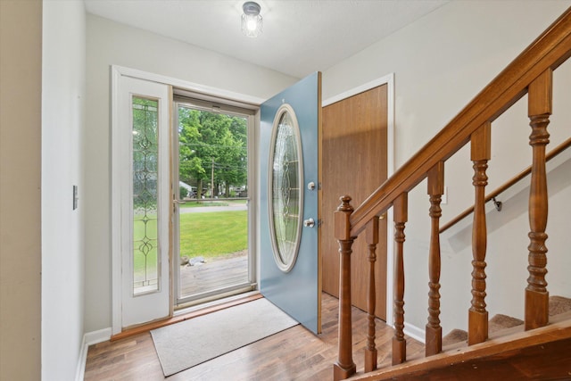 123 N F St, Trufant, MI 49347 - foyer entrance with wood finished floors and stairway