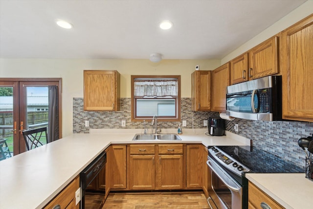 123 N F St, Trufant, MI 49347 - kitchen featuring appliances with stainless steel finishes, a sink, backsplash, light countertops, and recessed lighting
