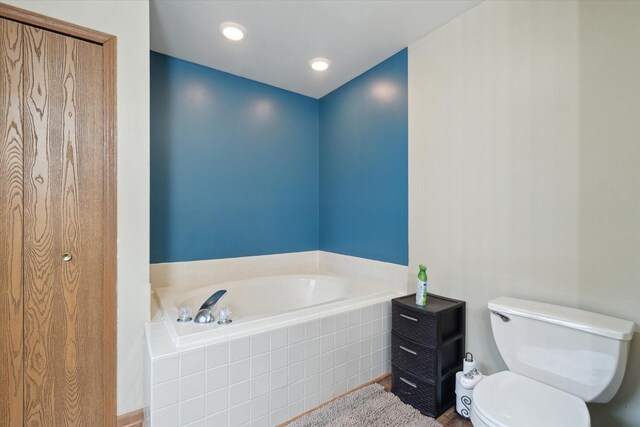 123 N F St, Trufant, MI 49347 - bathroom featuring a garden tub and toilet