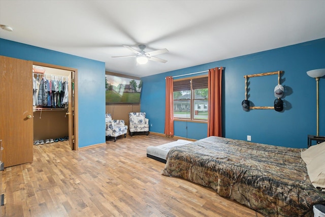 123 N F St, Trufant, MI 49347 - bedroom featuring wood finished floors, ceiling fan, baseboards, and a spacious closet