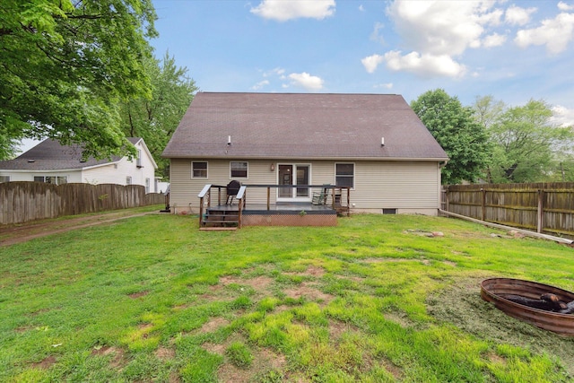 123 N F St, Trufant, MI 49347 - back of property featuring a wooden deck, a fire pit, and french doors