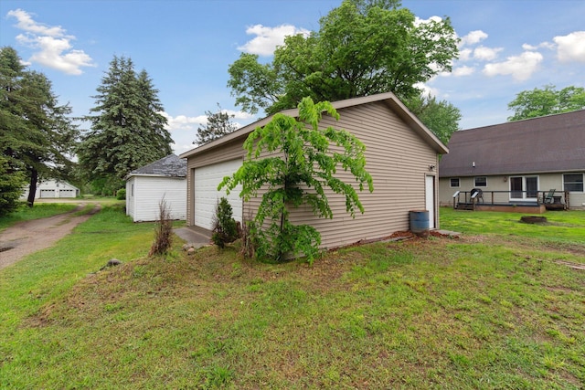 123 N F St, Trufant, MI 49347 - view of side of home featuring a deck, a yard, and a detached garage