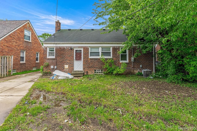 1860 Moran Ave, Lincoln Park, MI 48146 - back of house with a chimney, brick siding, entry steps, driveway, and roof with shingles