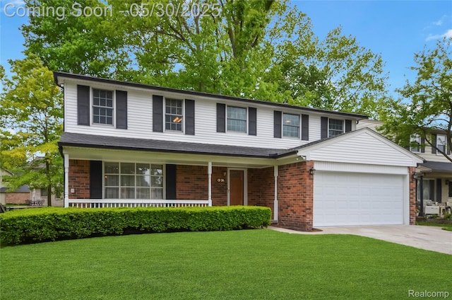 13936 Grove Park Dr, Sterling Heights, MI 48313 - traditional home featuring a garage, driveway, a front yard, covered porch, and brick siding