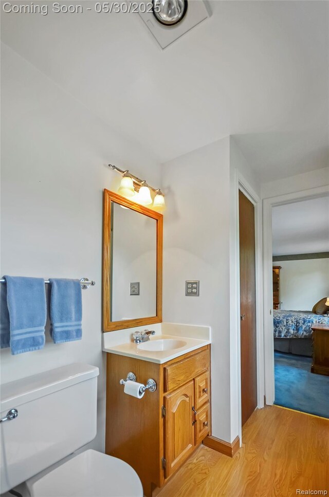 13936 Grove Park Dr, Sterling Heights, MI 48313 - ensuite bathroom featuring toilet, wood finished floors, and vanity