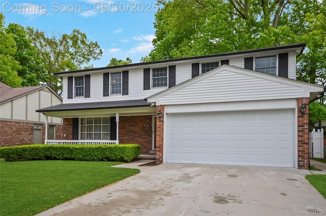 13936 Grove Park Dr, Sterling Heights, MI 48313 - view of front facade with brick siding, concrete driveway, a garage, a front lawn, and covered porch