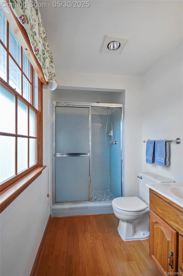13936 Grove Park Dr, Sterling Heights, MI 48313 - bathroom featuring wood finished floors, vanity, toilet, and a stall shower