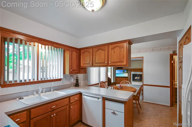 13936 Grove Park Dr, Sterling Heights, MI 48313 - kitchen featuring dishwasher, a sink, a peninsula, brown cabinetry, and light countertops