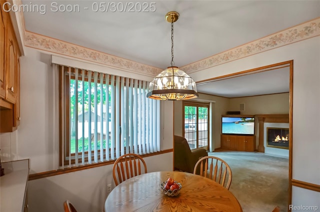 13936 Grove Park Dr, Sterling Heights, MI 48313 - carpeted dining area featuring a chandelier and a warm lit fireplace