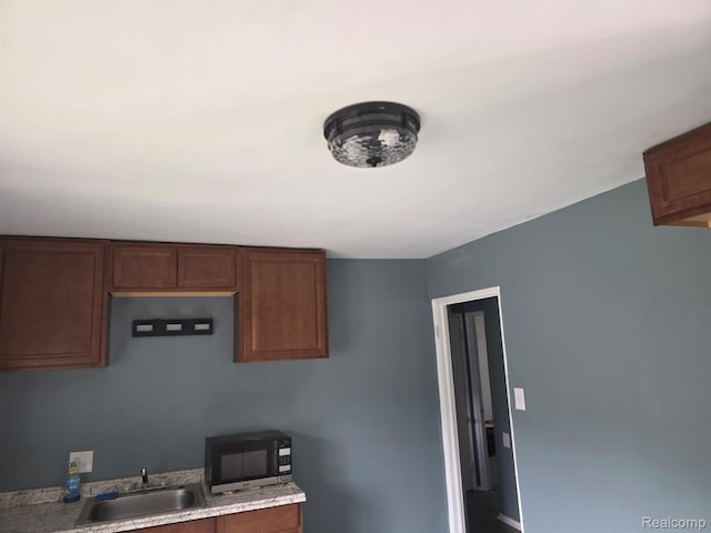 11717 Marlowe St, Detroit, MI 48227 - kitchen with a sink, light countertops, and baseboards