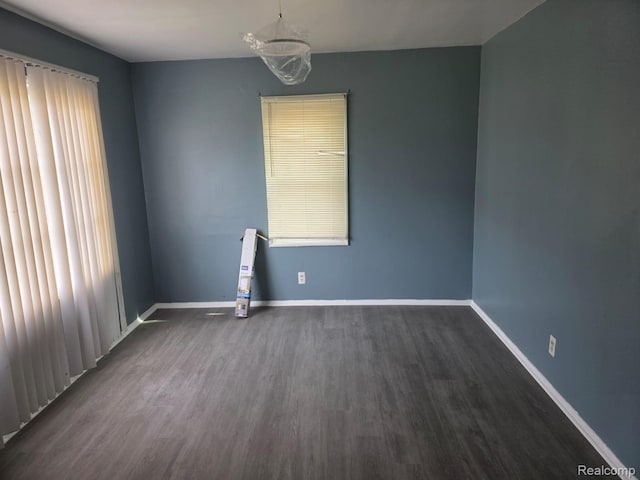 11717 Marlowe St, Detroit, MI 48227 - empty room with dark wood finished floors and baseboards