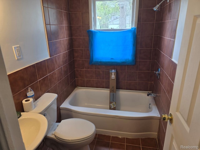 11717 Marlowe St, Detroit, MI 48227 - bathroom featuring toilet, tile walls, tile patterned floors, and bathtub / shower combination