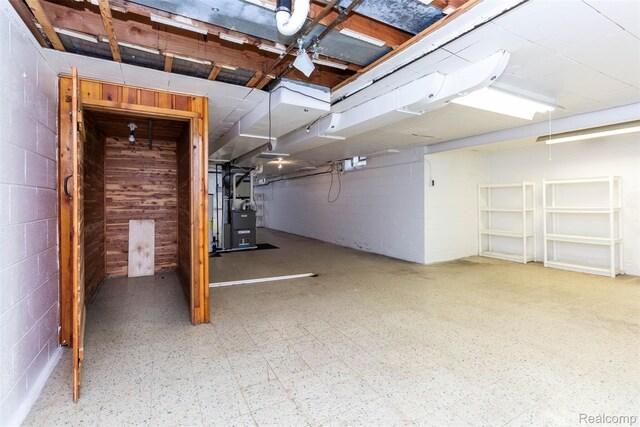 20550 Fairway Ln, Grosse Pointe Woods, MI 48236 - below grade area featuring heating unit, concrete block wall, and tile patterned floors