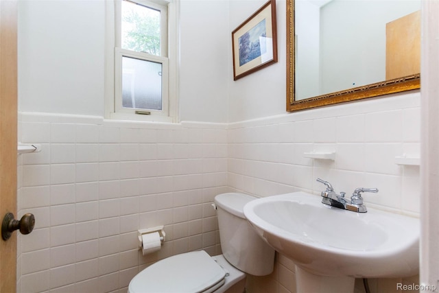 20550 Fairway Ln, Grosse Pointe Woods, MI 48236 - bathroom with tile walls, toilet, a wainscoted wall, and a sink