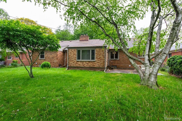 20550 Fairway Ln, Grosse Pointe Woods, MI 48236 - view of front of house with brick siding, a front yard, and a chimney