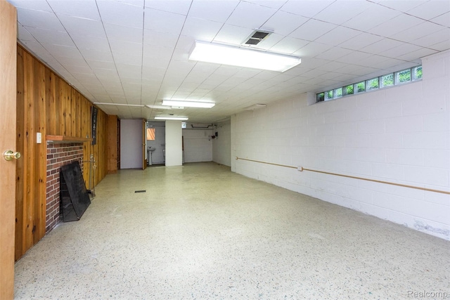 20550 Fairway Ln, Grosse Pointe Woods, MI 48236 - basement featuring a brick fireplace, concrete block wall, and wooden walls