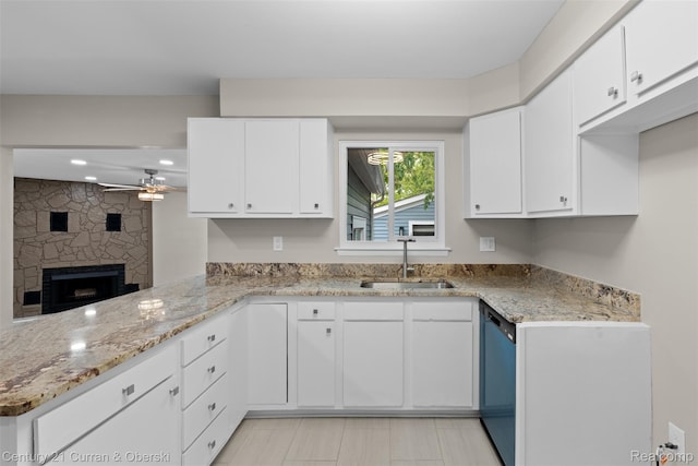 6262 Garden Ct, Warren, MI 48091 - kitchen featuring a sink, ceiling fan, dishwashing machine, a peninsula, and light stone countertops