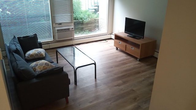 1531 Packard St Unit 2, Ann Arbor, MI 48104 - living room featuring wood finished floors, a baseboard radiator, and cooling unit