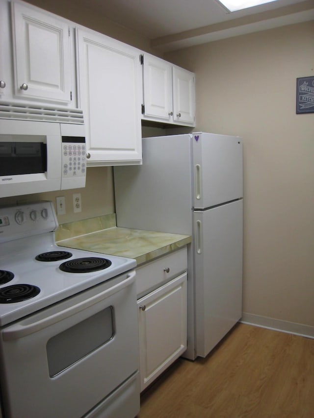 1531 Packard St Unit 2, Ann Arbor, MI 48104 - kitchen featuring white appliances, light countertops, light wood finished floors, and white cabinets