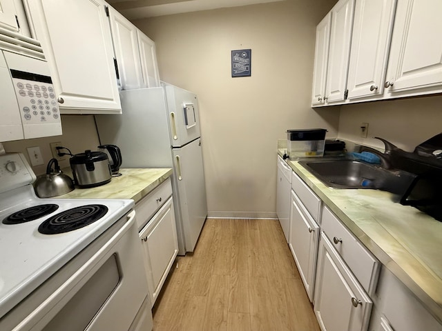 1531 Packard St Unit 2, Ann Arbor, MI 48104 - kitchen featuring white appliances, a sink, white cabinetry, light wood-style flooring, and light countertops